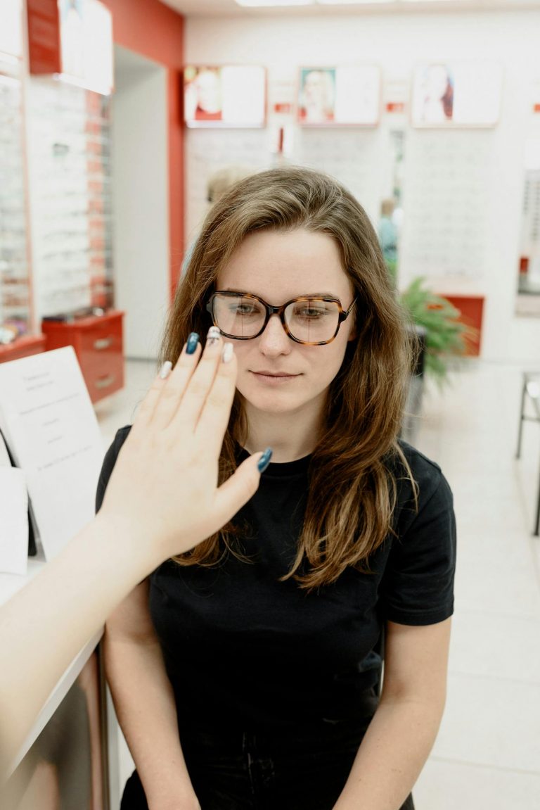 A female patient undergoes an eye examination in a modern clinic setting, with focus on health care.