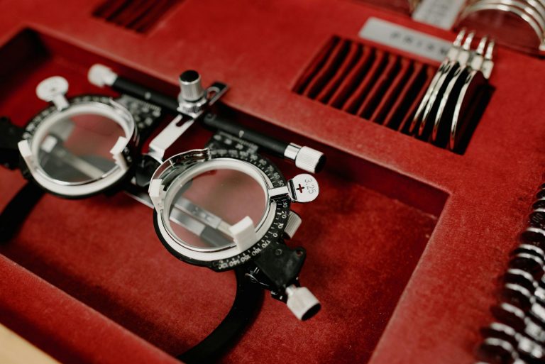 Close-up of an optometry diagnostic tool set in a red case, emphasizing precision.